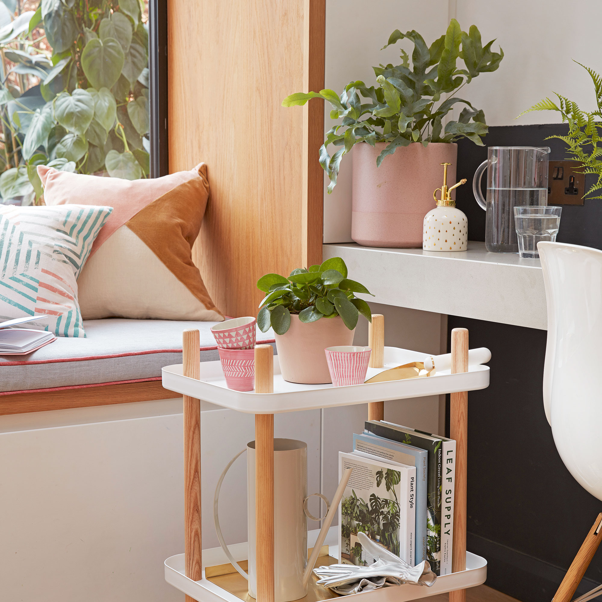 houseplants arranged in living area on a trolley and kitchen island