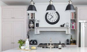 Grey kitchen with grey pendant lights and clock