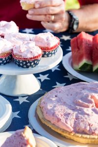 Picnic food set out on a stars and stripes tablecloth