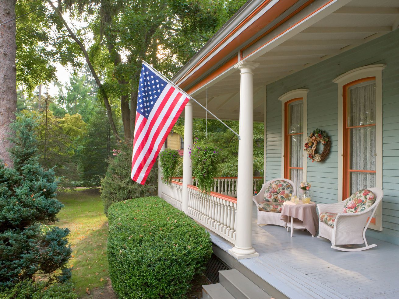 An American flag hangs from a Victorian home