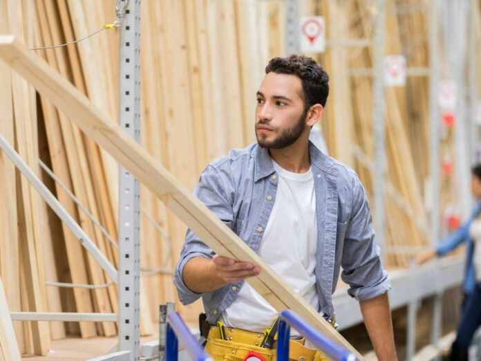 Man shopping for lumber in a large store