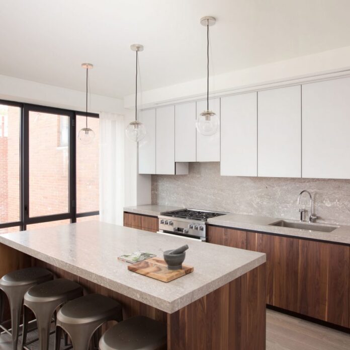 A kitchen with pale granite surfaces