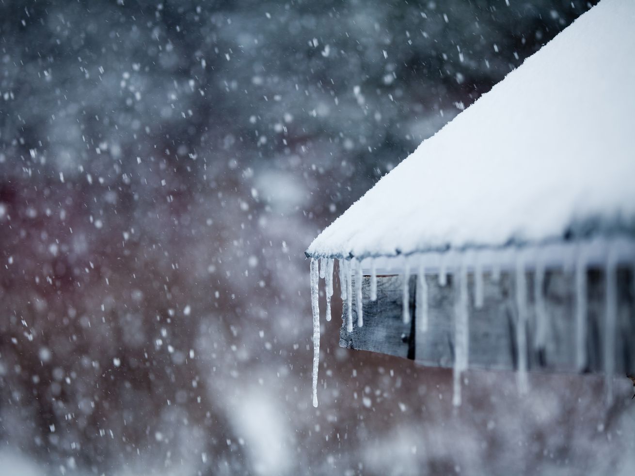A roof covered in snow and ice during a snow storm