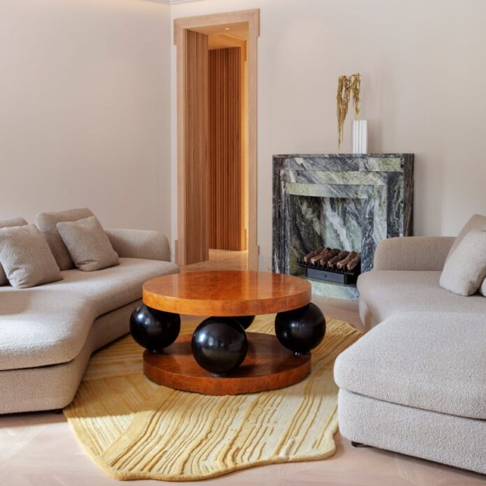 Circular wooden table with ball legs in Stockholm flat