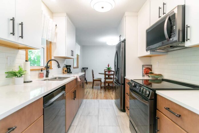 White and natural wood slab kitchen cabinets with white subway tile backsplash