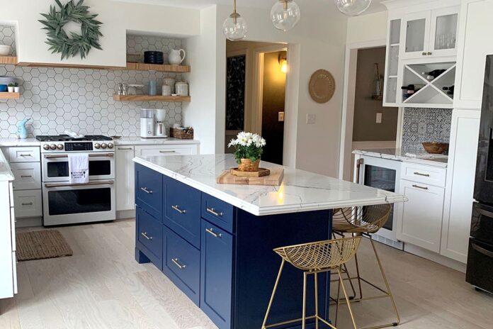 Shaker white kitchen cabinets with a blue shaker island and matching white appliances