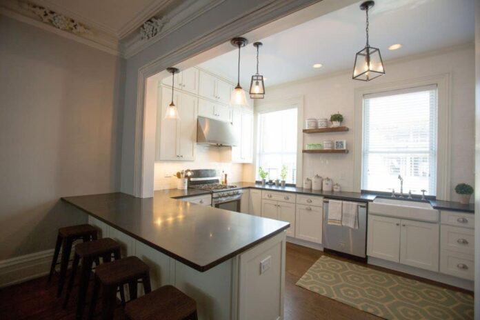 Photo gallery of remodeled kitchen features CliqStudios Shaker Painted White cabinets with nickel finish cup pulls