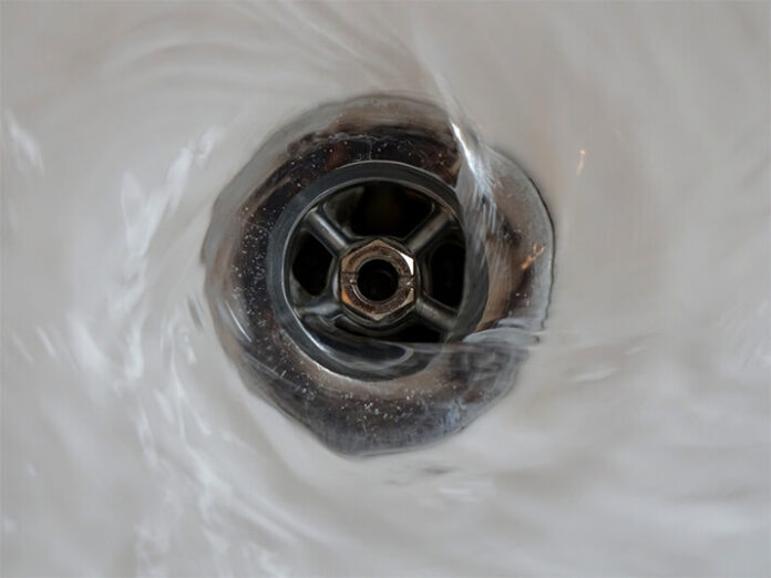 Water spins around a shower drain..