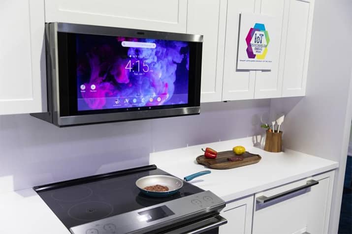 GE interactive smart kitchen hood above cooking range.