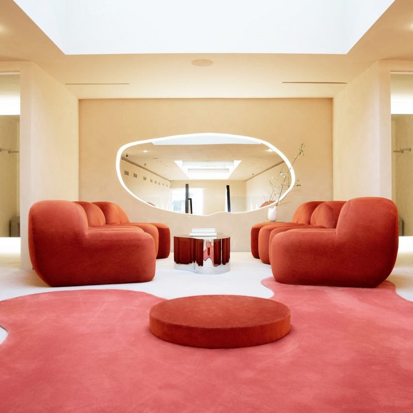 Fitting room lounge with red satin furniture and carpet