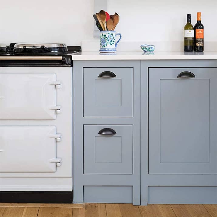 Shaker style cabinets with half moon black cup pulls.