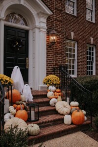 Brick house front porch decorated for Halloween night.