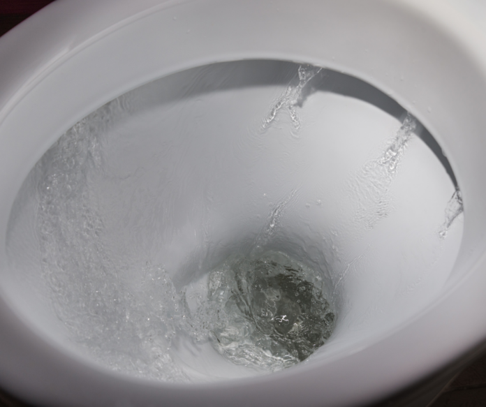 An image of a toilet with water running continuously, indicating the toilet running sound issue.