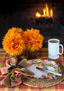 Thanksgiving table setting around the fire set with items from Old Time Pottery