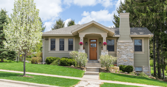 Small Craftsman style house with pillared awning atop the entrance door.