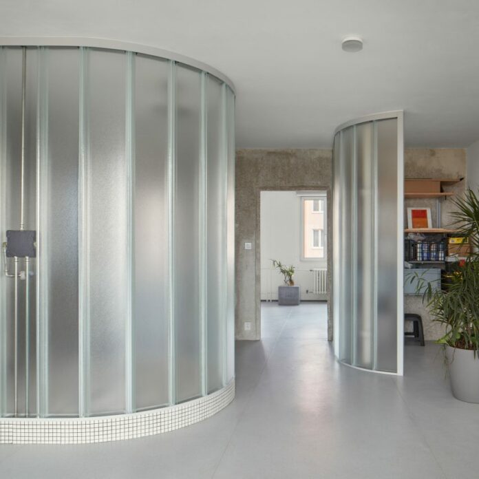 Neuhäusl Hunal renovate apartment in Prague using curved glass walls