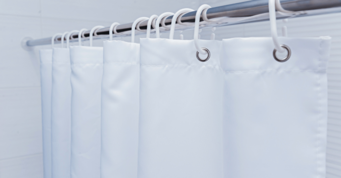 White standard shower curtain size with plastic hooks.