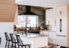 U-shaped white shaker kitchen design with modern black handles and green natural stone countertops and slab backsplash